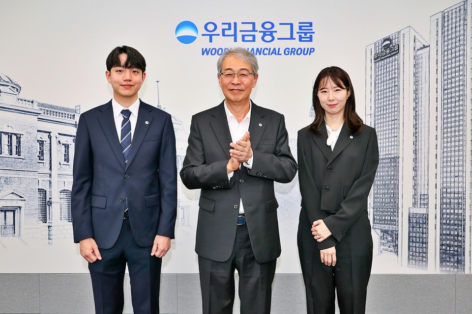 우리금융그룹 임종룡 회장이 동양생명·ABL생명 직원에게 디지털 선도의 의미가 담긴 새로운 그룹 보조휘장을 달아주고 있다. [사진=우리금융]